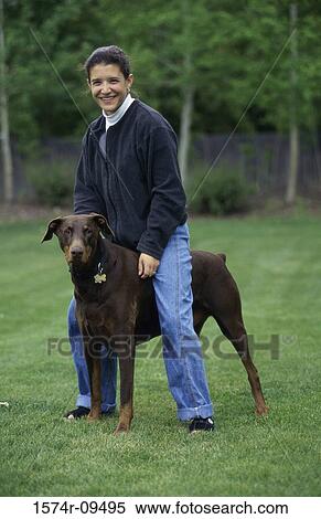 Portrait of a young woman playing with her dog View Large Photo Image Stock Photography - Portrait of a young woman playing with her dog. Fotosearch