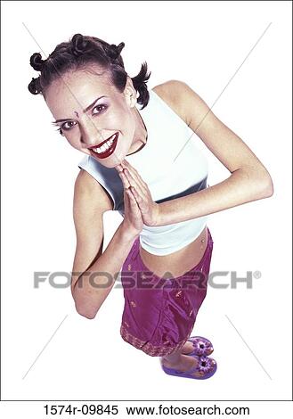 Portrait of a young woman standing with her hands together View Large Photo Image Stock Photography - Portrait of a young woman standing with her hands together. Fotosearch