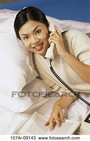 Portrait of a young woman talking on a telephone View Large Photo Image Stock Image - Portrait of a young woman talking on a telephone. Fotosearch