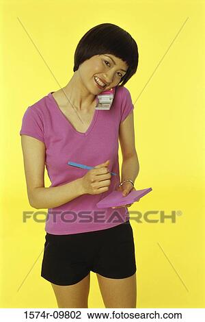 Portrait of a young woman talking on a mobile phone View Large Photo Image Stock Image - Portrait of a young woman talking on a mobile phone. Fotosearch