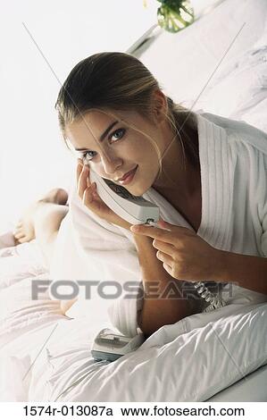 Portrait of a young woman talking on the telephone View Large Photo Image Stock Image - Portrait of a young woman talking on the telephone. Fotosearch