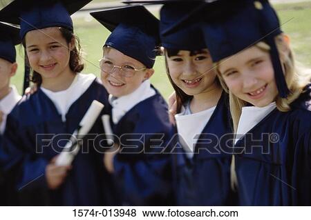 Stock Photo - Portrait of four children wearing graduation outfits holding diploma. Fotosearch