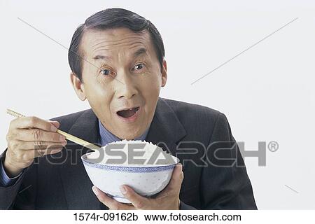 Portrait of man holding a bowl of rice View Large Photo Image Stock Image - Portrait of man holding a bowl of rice. Fotosearch