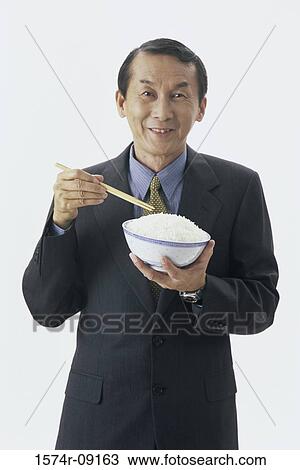 Portrait of man holding a bowl of rice View Large Photo Image Stock Image - Portrait of man holding a bowl of rice. Fotosearch