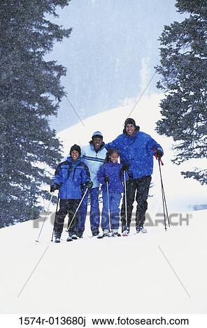Portrait of parents standing with their two children in snow View Large Photo Image Stock Image - Portrait of parents standing with their two children in snow. Fotosearch