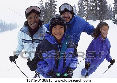 Portrait of parents standing with their two children in snow View Large Photo Image Stock Image - Portrait of parents standing with their two children in snow. Fotosearch