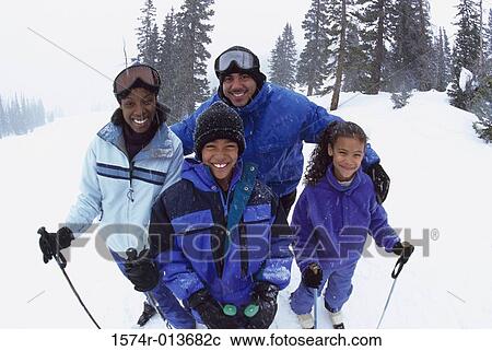 Portrait of parents standing with their two children in snow View Large Photo Image Stock Image - Portrait of parents standing with their two children in snow. Fotosearch