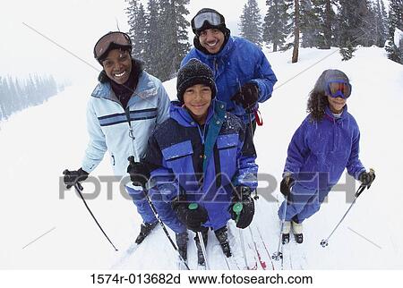 Portrait of parents standing with their two children in snow View Large Photo Image Stock Image - Portrait of parents standing with their two children in snow. Fotosearch