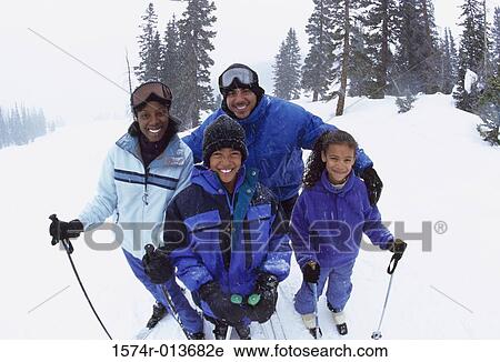 Portrait of parents standing with their two children in snow View Large Photo Image Stock Image - Portrait of parents standing with their two children in snow. Fotosearch