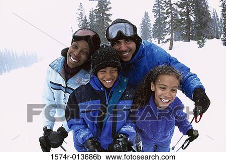 Portrait of parents standing with their two children in snow View Large Photo Image Stock Image - Portrait of parents standing with their two children in snow. Fotosearch