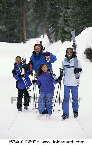 Portrait of parents walking with their two children in snow View Large Photo Image Stock Image - Portrait of parents walking with their two children in snow. Fotosearch