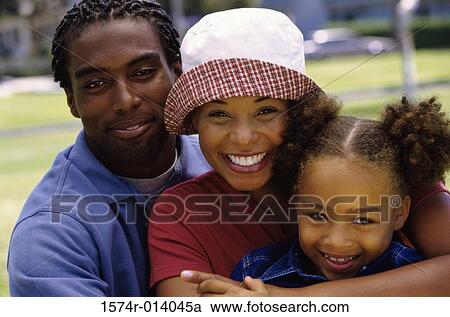Portrait of parents with their daughter smiling View Large Photo Image Stock Image - Portrait of parents with their daughter smiling. Fotosearch