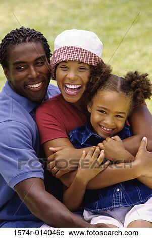 Stock Image - Portrait of parents with their daughter. Fotosearch