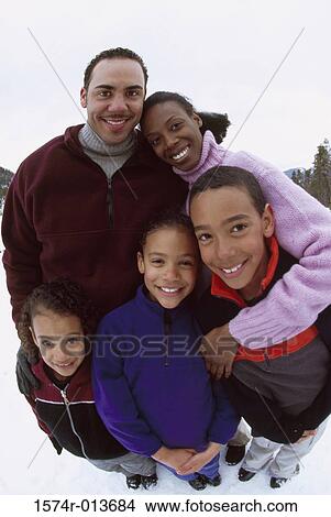 Picture - Portrait of parents with their son and two daughters smiling. Fotosearch