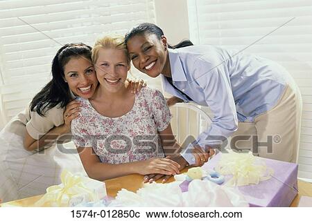 Portrait of three young women smiling at a baby shower View Large Photo Image Stock Image - Portrait of three young women smiling at a baby shower. Fotosearch