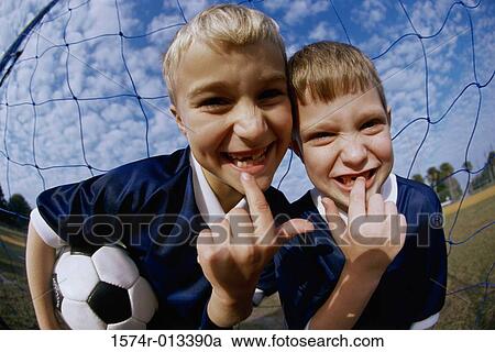Stock Image - Portrait of two boys showing their missing teeth. Fotosearch