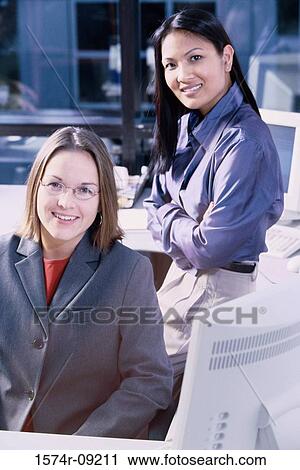 Portrait of two businesswomen in an office View Large Photo Image Stock Image - Portrait of two businesswomen in an office. Fotosearch