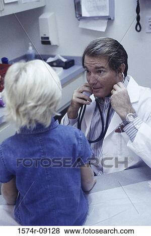 Stock Photo - Rear view of a child sitting in front of a male doctor. Fotosearch