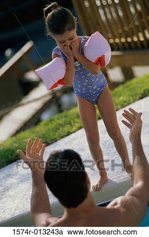 Stock Image - Rear view of a father calling his daughter. Fotosearch