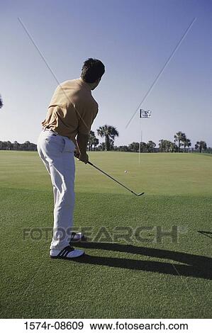 Rear view of a man playing golf View Large Photo Image Stock Photo - Rear view of a man playing golf. Fotosearch