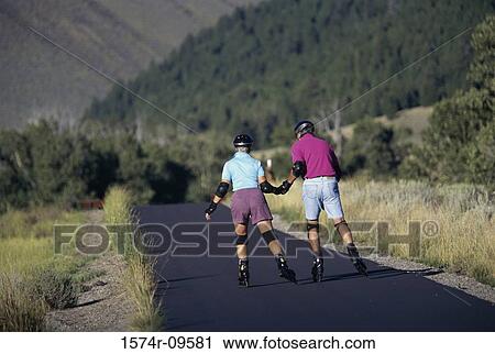Rear view of a senior couple roller skating View Large Photo Image Stock Image - Rear view of a senior couple roller skating. Fotosearch