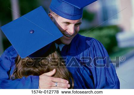 Rear view of a young graduate couple congratulating each other View Large Photo Image Stock Photo - Rear view of a young graduate couple congratulating each other. Fotosearch
