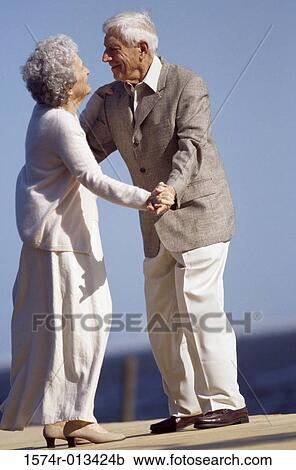 Senior couple dancing on a pier View Large Photo Image Stock Image - Senior couple dancing on a pier. Fotosearch