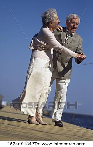 Senior couple dancing on a pier View Large Photo Image Stock Image - Senior couple dancing on a pier. Fotosearch