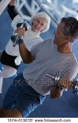 Senior couple exercising in a health club View Large Photo Image Stock Image - Senior couple exercising in a health club. Fotosearch