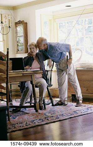 Senior couple in front of a laptop View Large Photo Image Stock Photo - Senior couple in front of a laptop. Fotosearch