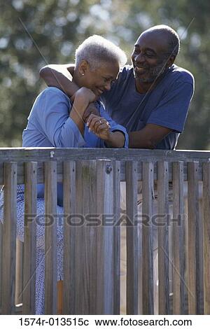 Senior couple leaning against a railing View Large Photo Image Stock Image - Senior couple leaning against a railing. Fotosearch
