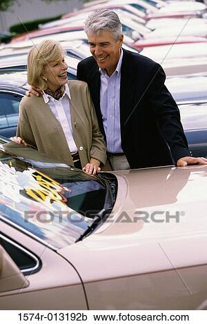 Senior couple looking at a car in a car lot View Large Photo Image Stock Image - Senior couple looking at a car in a car lot. Fotosearch