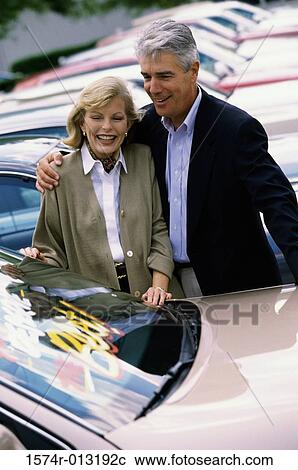 Senior couple looking at a car in a car lot View Large Photo Image Stock Image - Senior couple looking at a car in a car lot. Fotosearch