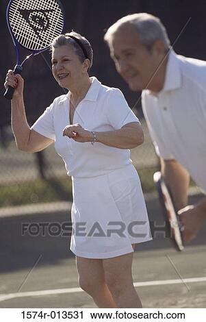 Senior couple playing tennis View Large Photo Image Stock Image - Senior couple playing tennis. Fotosearch
