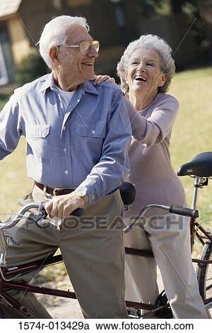 Senior couple riding a tandem bicycle View Large Photo Image Stock Image - Senior couple riding a tandem bicycle. Fotosearch