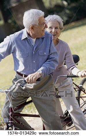 Senior couple riding a tandem bicycle View Large Photo Image Stock Image - Senior couple riding a tandem bicycle. Fotosearch