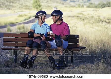 Senior couple sitting together on a bench View Large Photo Image Stock Image - Senior couple sitting together on a bench. Fotosearch