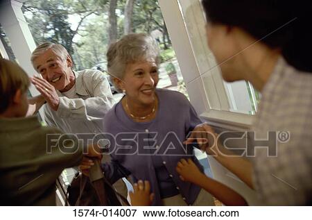 Stock Photo - Senior couple standing at the front door. Fotosearch