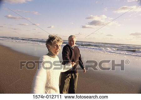 Senior couple walking on the beach View Large Photo Image Stock Image - Senior couple walking on the beach. Fotosearch