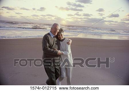 Senior couple walking on the beach View Large Photo Image Stock Photography - Senior couple walking on the beach. Fotosearch