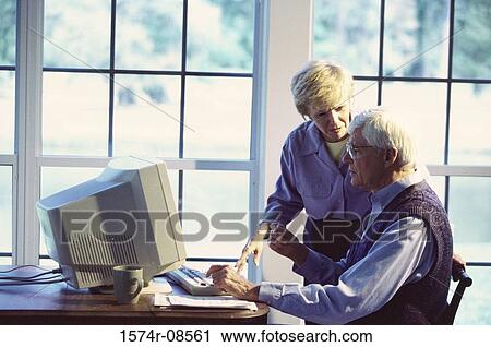 Stock Image - Senior couple working on a computer. Fotosearch
