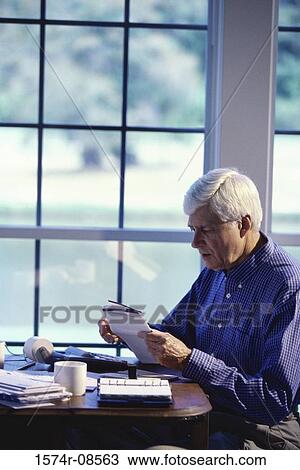 Senior man sitting calculating bills View Large Photo Image Stock Image - Senior man sitting calculating bills. Fotosearch