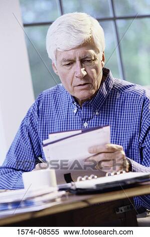 Senior man writing a check View Large Photo Image Stock Photography - Senior man writing a check. Fotosearch
