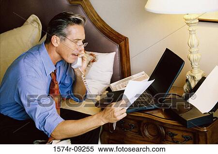 Side profile of a businessman talking on a telephone View Large Photo Image Stock Photography - Side profile of a businessman talking on a telephone. Fotosearch
