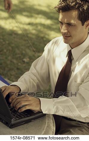 Side profile of a businessman working on a laptop View Large Photo Image Stock Image - Side profile of a businessman working on a laptop. Fotosearch