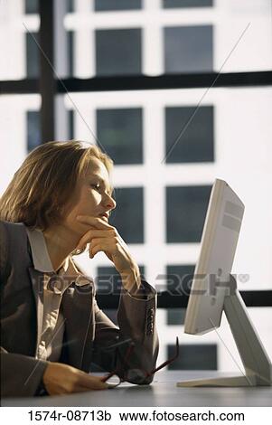 Side profile of a businesswoman sitting in front of a computer monitor View Large Photo Image Stock Image - Side profile of a businesswoman sitting in front of a computer monitor. Fotosearch