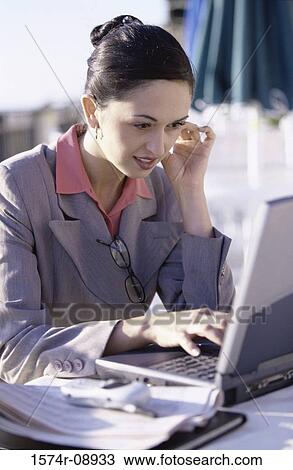 Side profile of a businesswoman operating a laptop View Large Photo Image Stock Image - Side profile of a businesswoman operating a laptop. Fotosearch