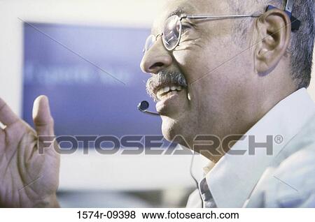 Side profile of a customer service representative wearing a headset View Large Photo Image Stock Photo - Side profile of a customer service representative wearing a headset. Fotosearch