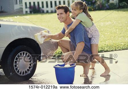 Side profile of a father washing a car with his daughter hugging him from behind View Large Photo Image Stock Image - Side profile of a father washing a car with his daughter hugging him from behind. Fotosearch