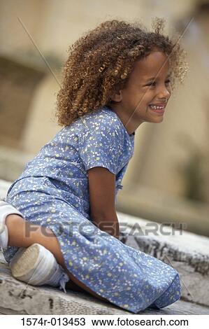 Stock Image - Side profile of a girl smiling. Fotosearch